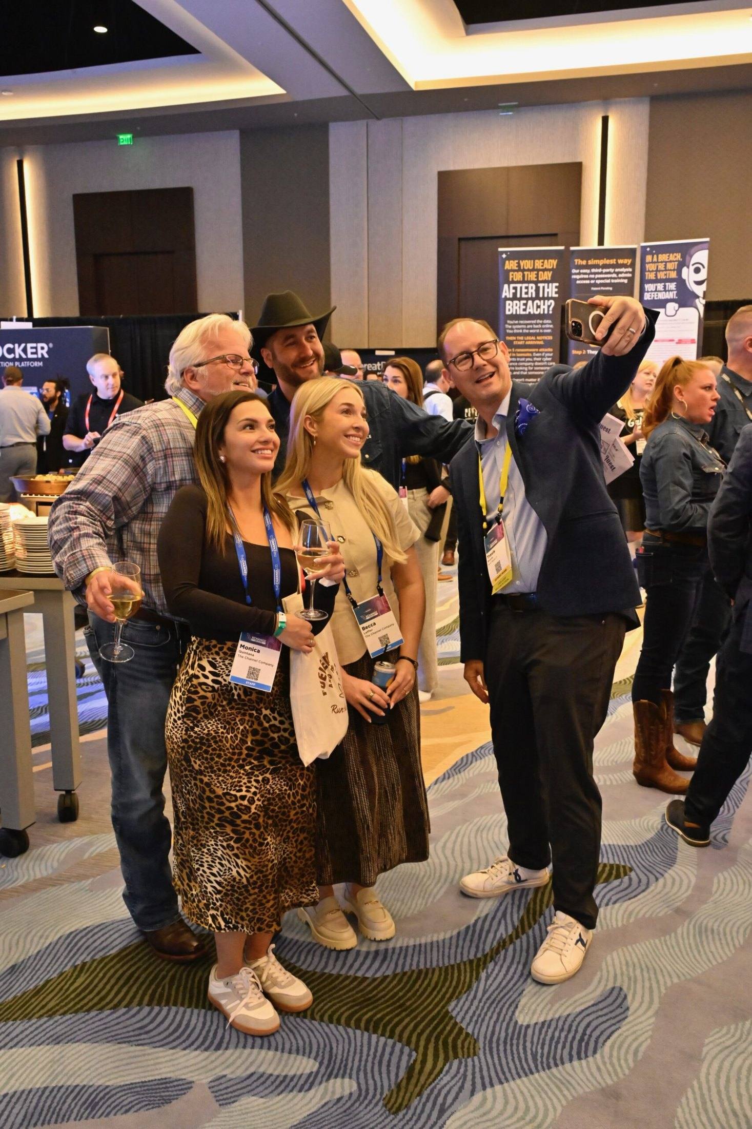 Travis Woods taking a group selfie with MSP community members at a channel event