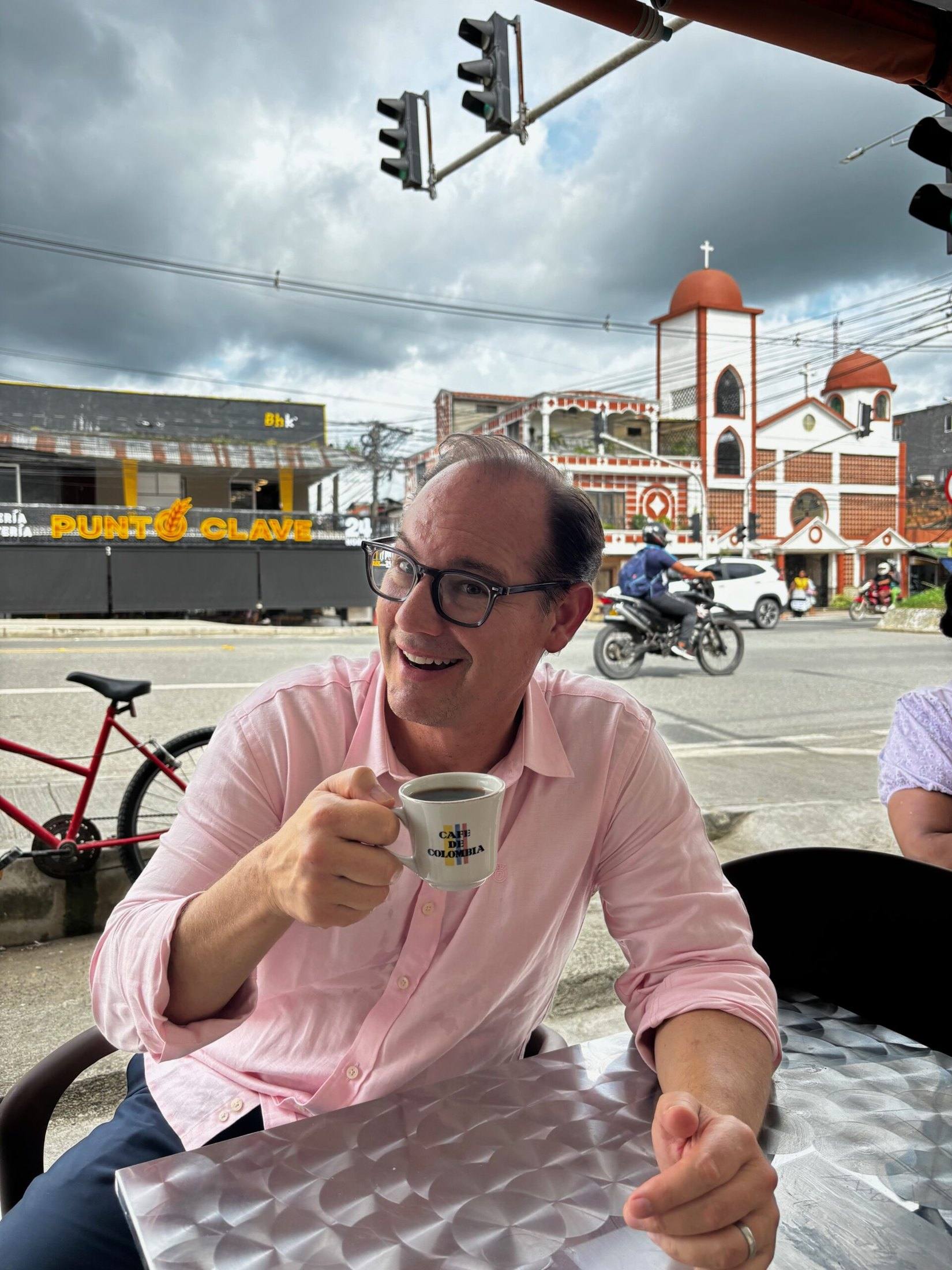 Travis Woods enjoying a coffee at a cafe in a Colombian town