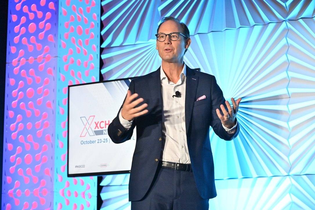 Travis Woods speaking on the main stage at an XChange event