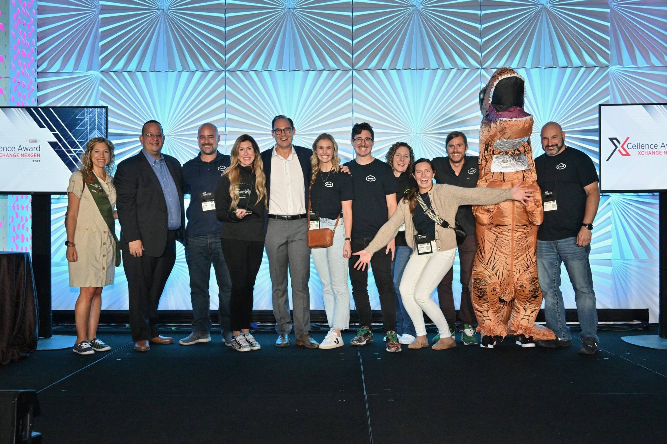 Travis Woods with a group of channel community members on stage at an XChange event