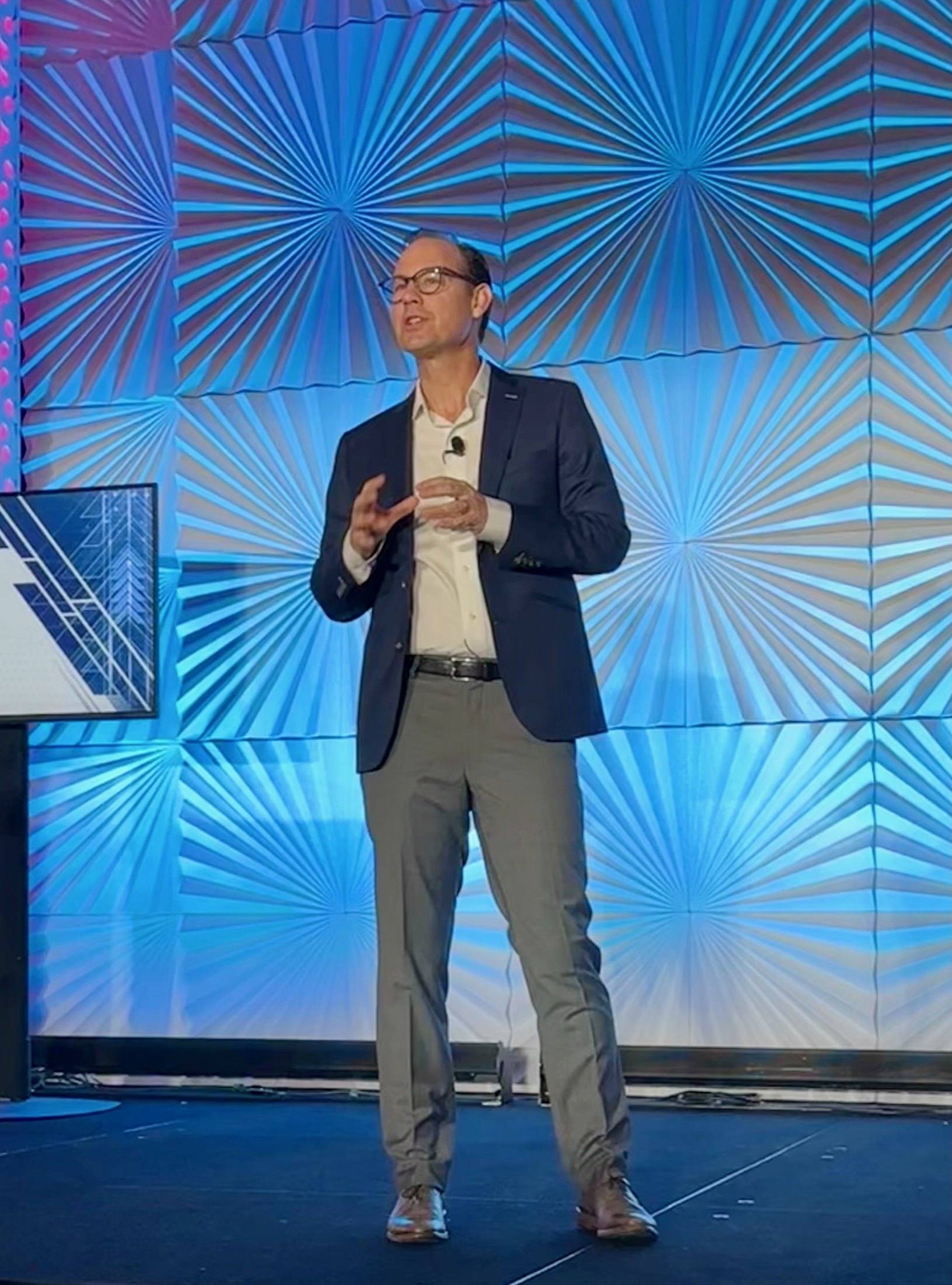 Travis Woods speaking on stage at XChange Security